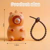 An orange capybara squeeze toy with a bubble blowing feature and a brown ring.