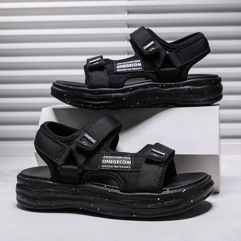 A pair of black OneGecom non-slip summer sport sandals displayed on a white box.