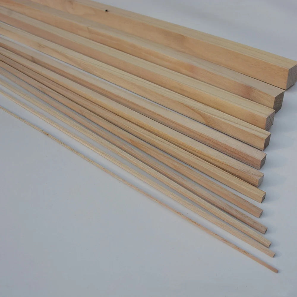 A collection of natural solid wood strips, approximately 250mm long, laid out diagonally.