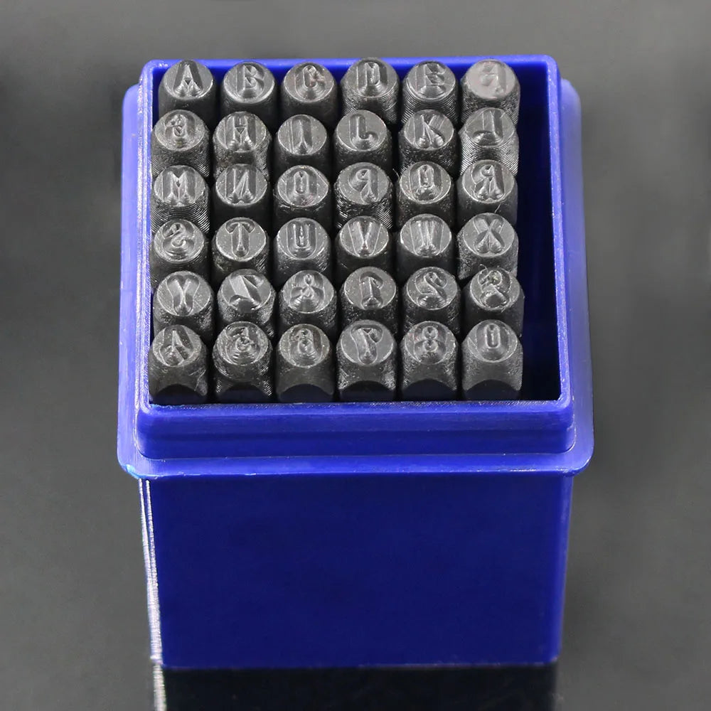 A blue plastic box holds a set of 36 carbon steel number and letter stamping tools.
