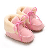 Pair of pink plush baby snow boots for girls and boys with anti-slip soles