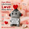 A handmade crochet donkey doll with a motivational card, featuring a red heart design.