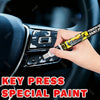 A hand applies special paint to touch up scratches on a car interior surface.