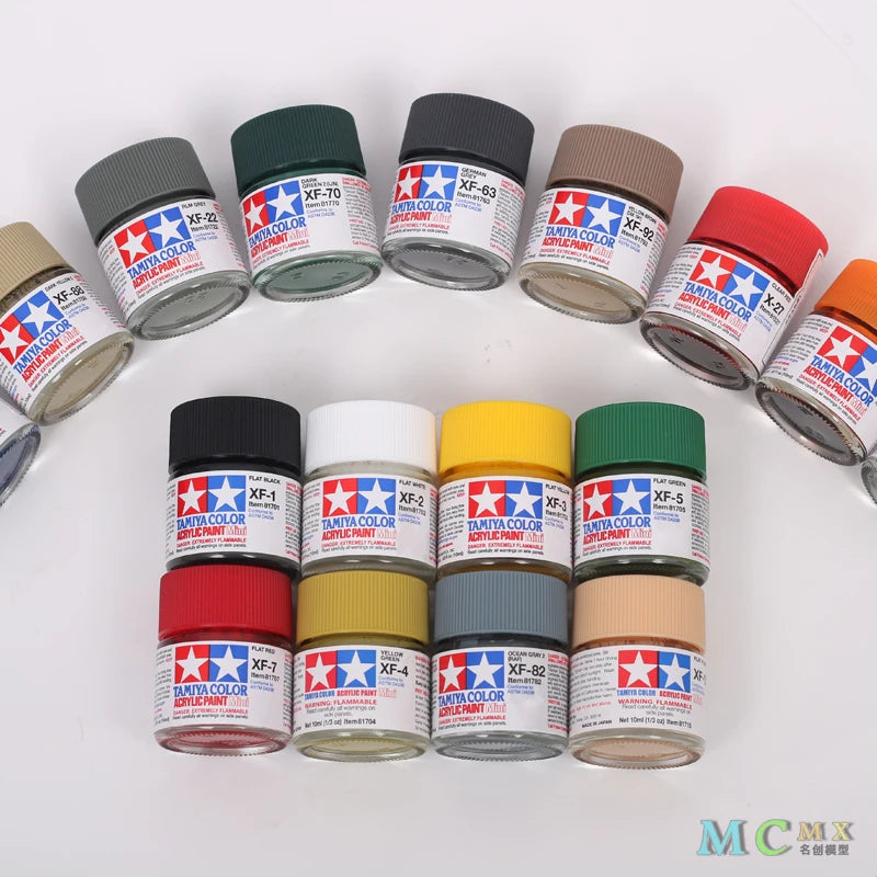A collection of matte acrylic paint pots in various colors and shades for model kits and miniatures.