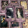 A collection of purple and gold oracle cards featuring dark and light imagery related to shadow work and goddess guidance