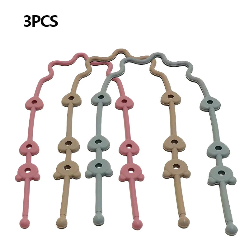 Three silicone pacifier clips with anti-drop chains in pink, beige, and light blue colors