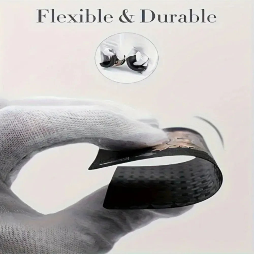 A hand holds a black card or item, demonstrating its flexible and durable nature.