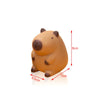An orange, squishy capybara stress relief toy with brown features, shown from the side.