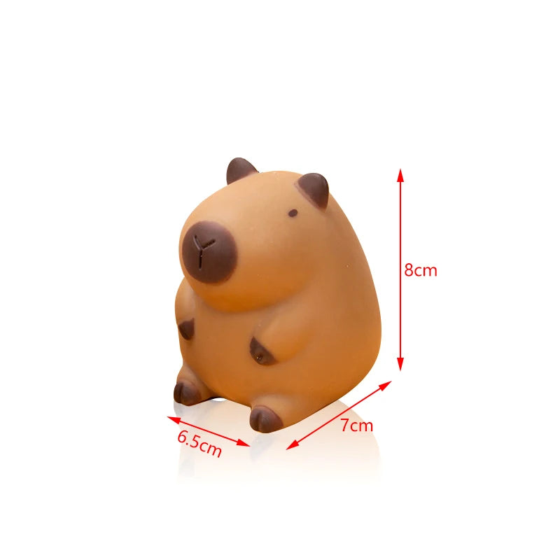 An orange, squishy capybara stress relief toy with brown features, shown from the side.