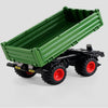 A green remote control tractor with a trailer is shown from above.