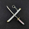A samurai sword keychain featuring a silver blade and white handle with a gold accent.