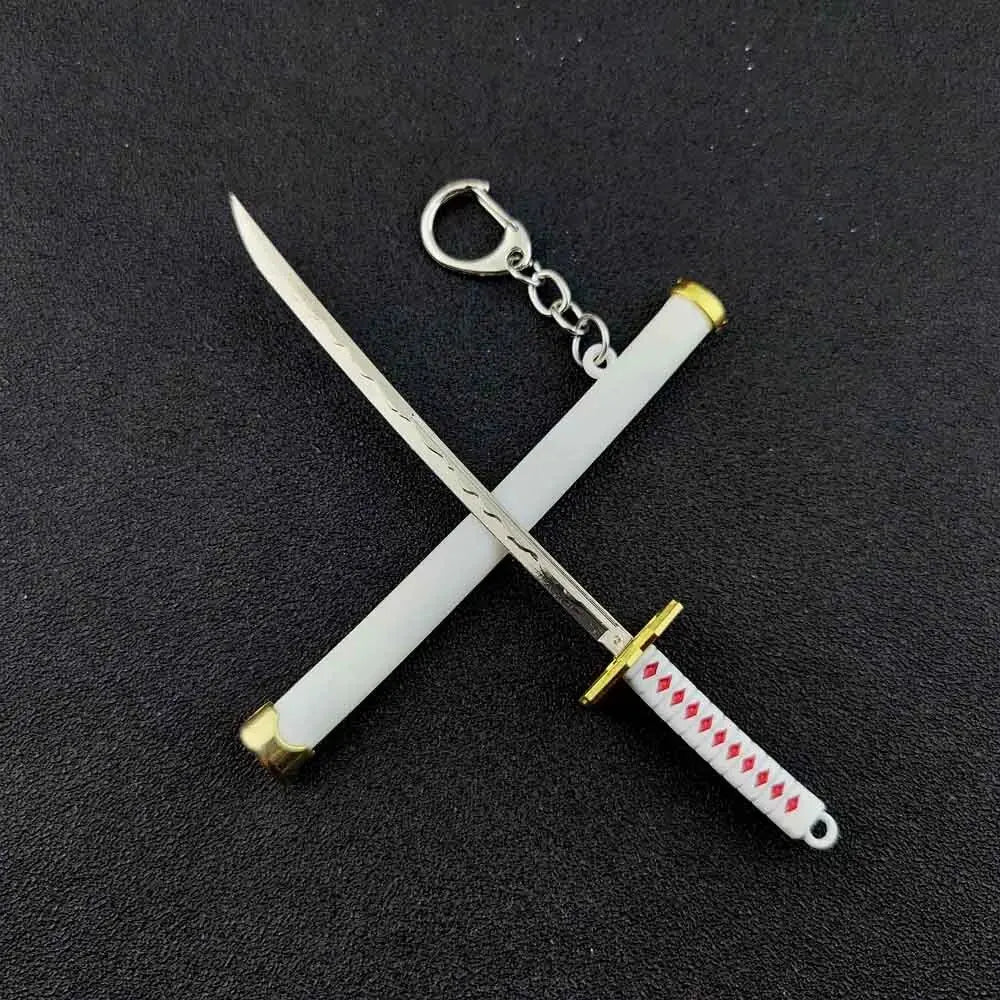 A samurai sword keychain featuring a silver blade and white handle with a gold accent.