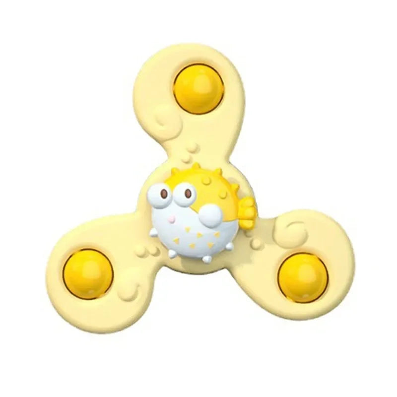 A yellow suction cup spinner bath toy for toddlers with a round, smiling face.