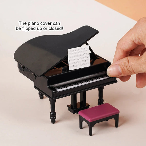 A black miniature piano cover is shown with sheet music inside, next to a purple piano bench.