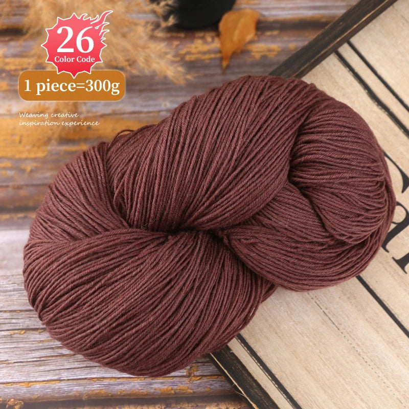 A ball of dark brown premium alpaca blend yarn is shown on a wooden surface.