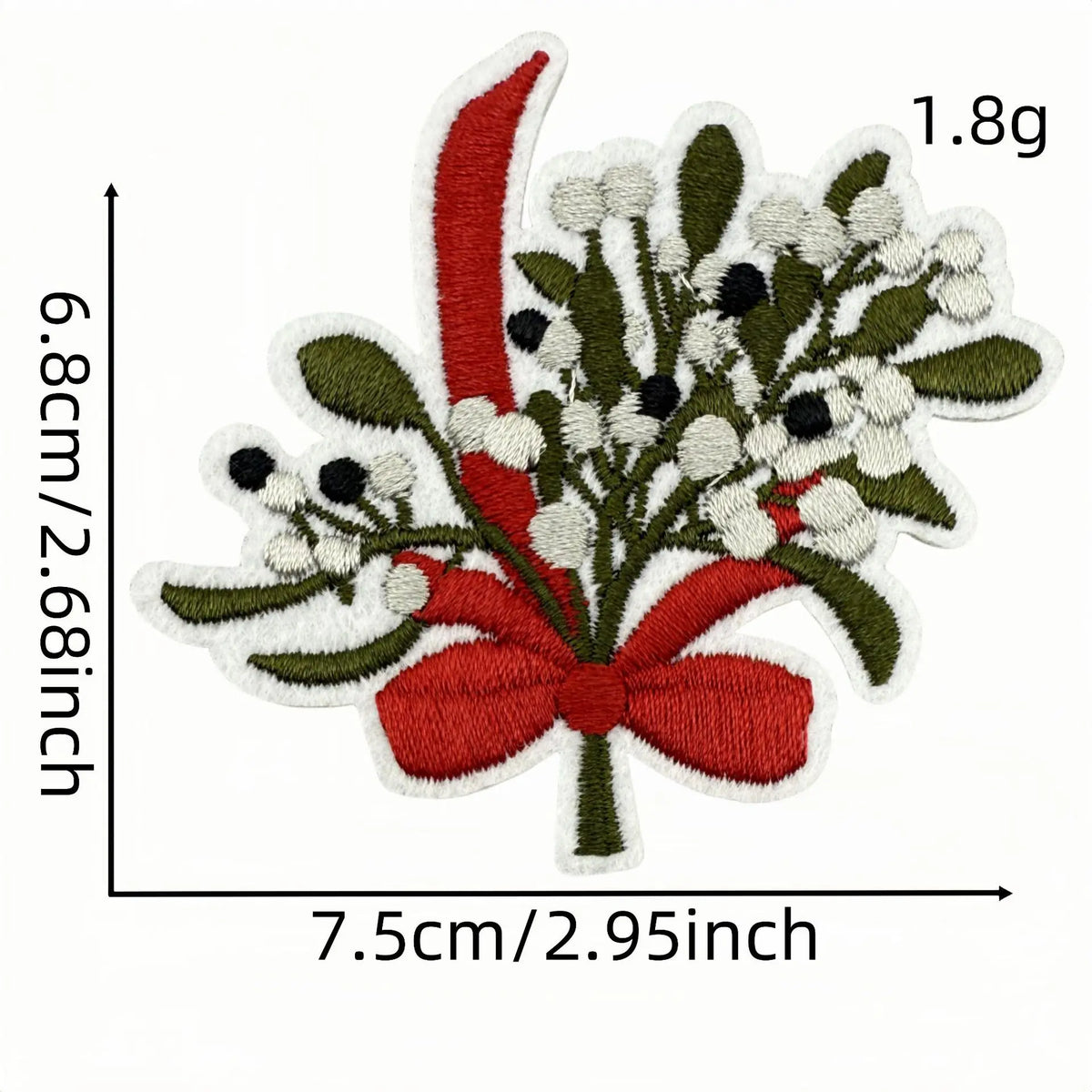A festive iron-on patch featuring a red bow tied with green foliage and white flowers on a cream background.