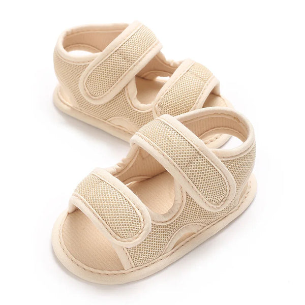 A pair of beige breathable summer baby pre-walker sandals for infants.