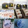 A collection of silicone soap and candle molds in various shapes and colors, including yellow, gray, white, and blue patterns