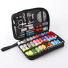 A black travel storage box containing a complete sewing kit with various tools like scissors and needles.