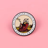 An enamel pin featuring a circular design with text surrounding an illustration of a bearded man smoking a pipe.