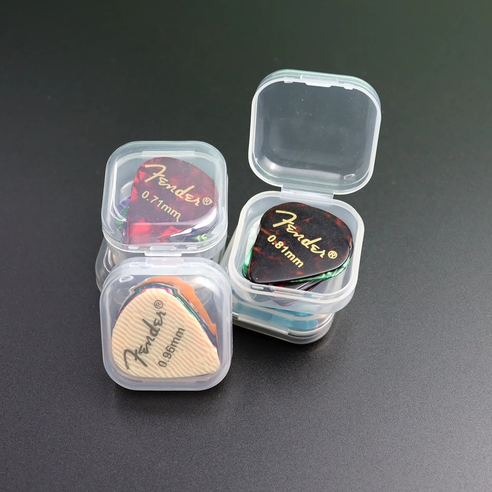 A variety pack of Fender guitar picks in a clear plastic storage box with individual compartments.
