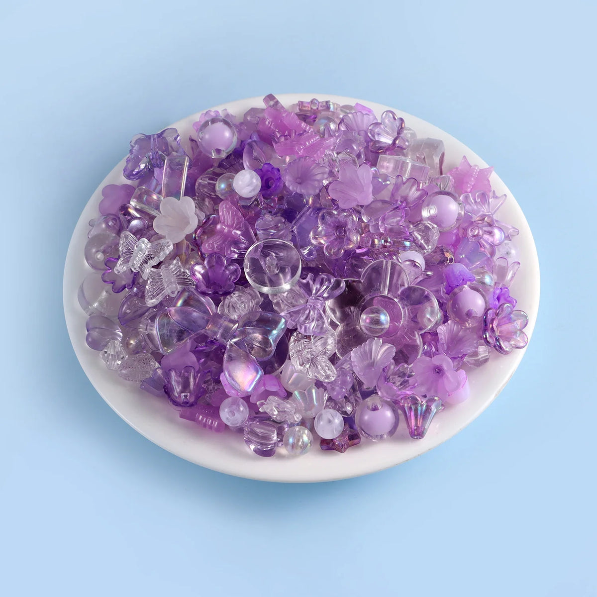 A pile of purple and lilac acrylic beads for DIY jewelry making