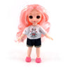 A pink-haired Articulated BJD princess doll wearing a white t-shirt and black shorts.