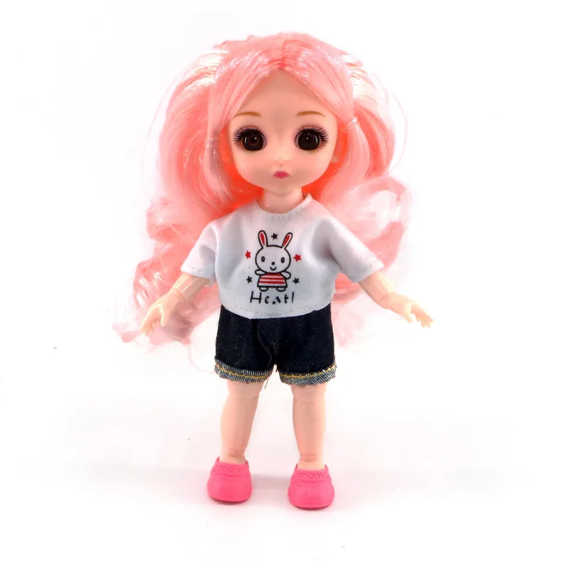 A pink-haired Articulated BJD princess doll wearing a white t-shirt and black shorts.
