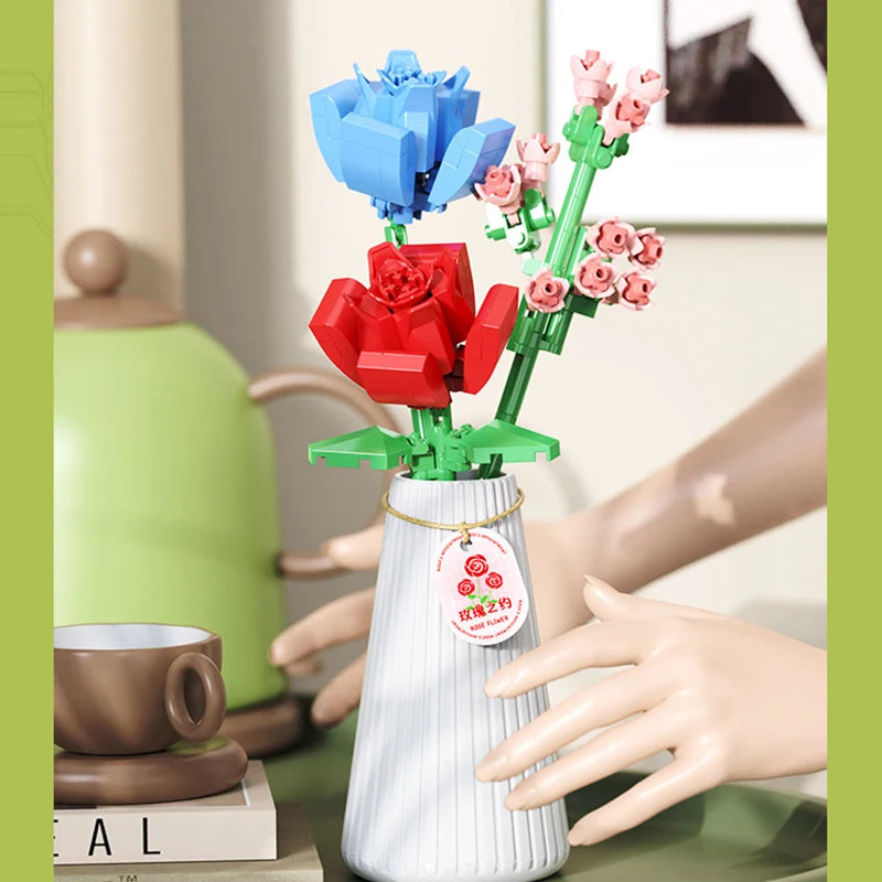 A set of flower bouquet building blocks with a vase, featuring red and pink roses and blue flowers.