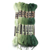 A set of six skeins of vibrant embroidery thread in various shades of green and teal for cross stitch and DIY crafts