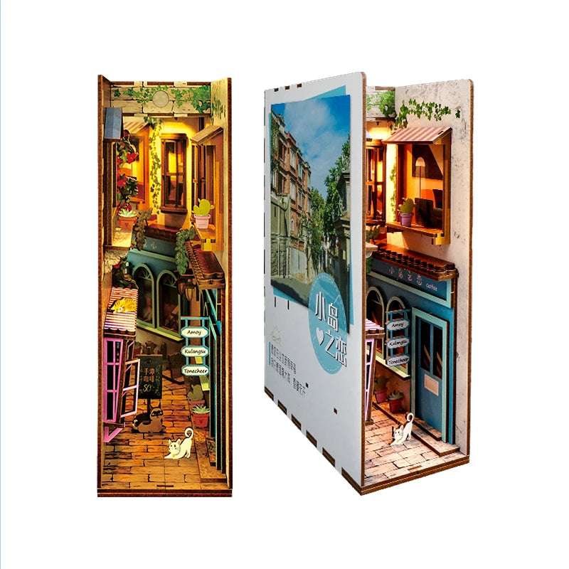 A DIY book nook kit featuring a detailed miniature scene with built-in LED lighting and a dust cover.