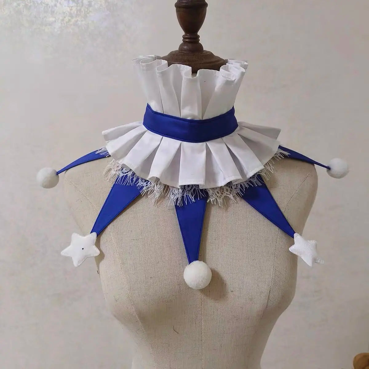 White and blue ruffled clown ruff collar accessory displayed on a mannequin.
