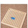 A wooden multiplication board game with numbered tiles for learning multiplication facts.