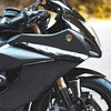 Close-up of a black motorcycle fairing featuring a 3D chrome Mexican flag emblem decal.