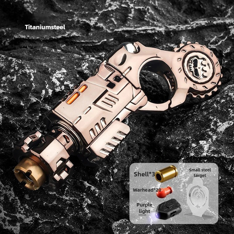 A titanium steel toy pistol and fidget spinner set with a round grip and barrel displayed on a dark, textured surface.