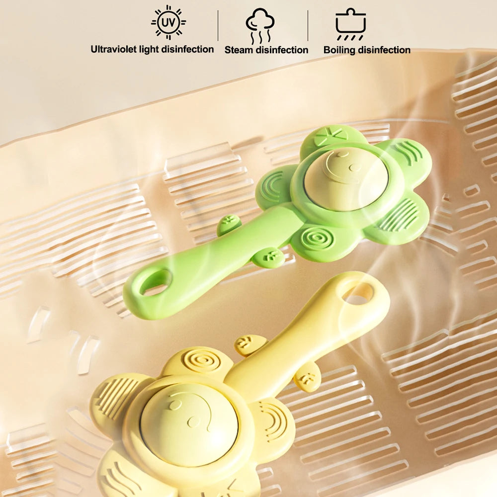 A light green and yellow 3-in-1 sensory teething rattle is shown on a silicone tray, demonstrating ultraviolet light disinfec