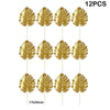 Twelve artificial gold tropical palm leaves on sticks for party decoration