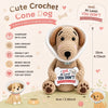 A handmade crochet cone dog doll with a motivational card sitting on a light background.