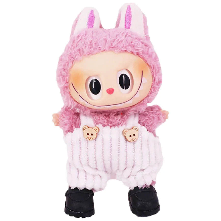 A pink Labubu plush doll wearing a pink hood and white strap pants with bear appliqués.