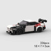 A black and white classic rally car building block set with red accents, shown from the side.