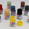 A collection of Tampiya Color Enamel paints labeled XF-7 through XF-18 in various bottles and caps.