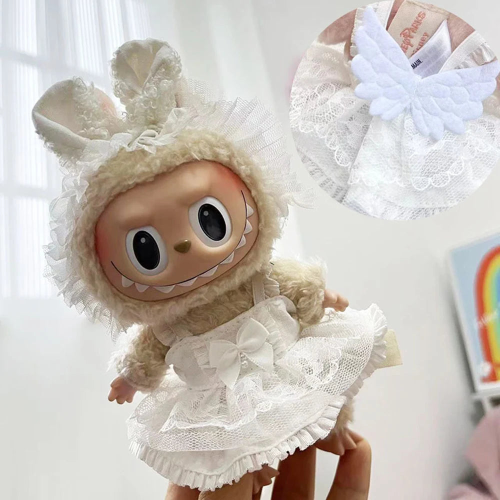 A mini doll wearing a white wedding dress outfit set with lace details and a sheer white veil