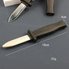 A realistic fake knife with a black handle and silver blade is shown next to a measuring scale.