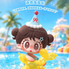 A cute figurine of a girl with brown hair and a conical hat is shown next to yellow puppy-shaped toys.