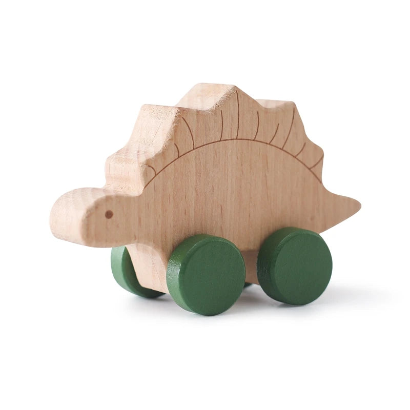 A wooden dinosaur toy car with green wheels for baby teethers.