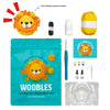 A box of Woebles learn to crochet kit for beginners, including yarn and tools, with a finished lion toy.