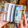 A hand holds a pack of Japanese vintage kawaii stickers for scrapbooking and journaling