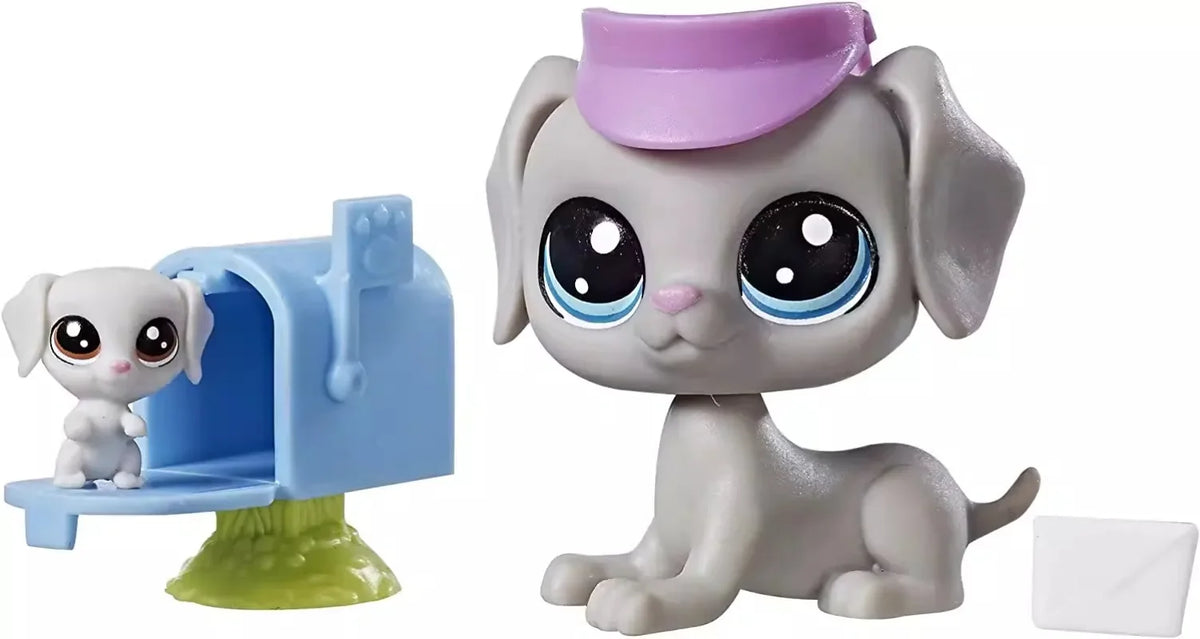 A gray dog figure with a pink hat sits next to a blue pet house toy.