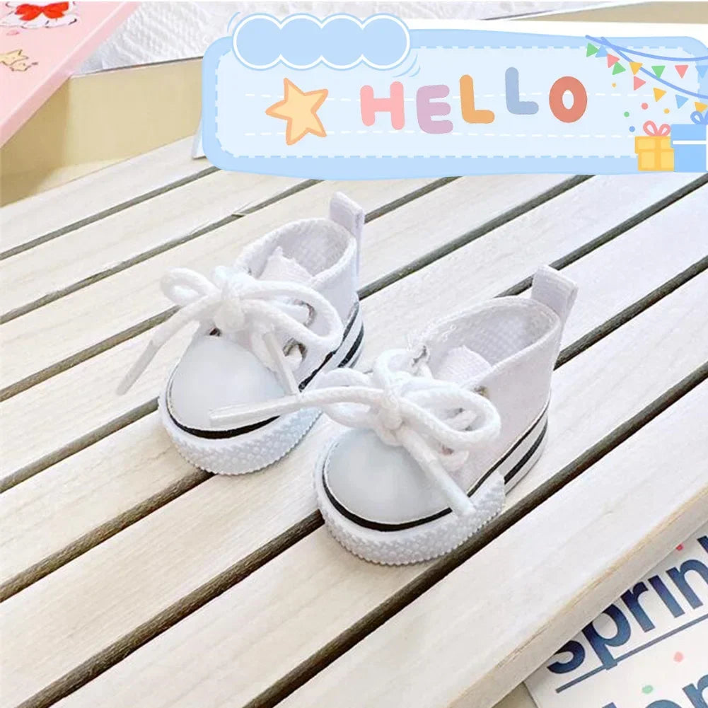 White casual sneakers with white laces and soles displayed on a wooden surface.