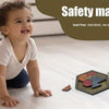 A smiling toddler is playing with a wooden hexagon tangram puzzle on a light surface.